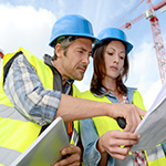 Construction manager and engineer working on building site Cutts Group Marketing & Sales Automation